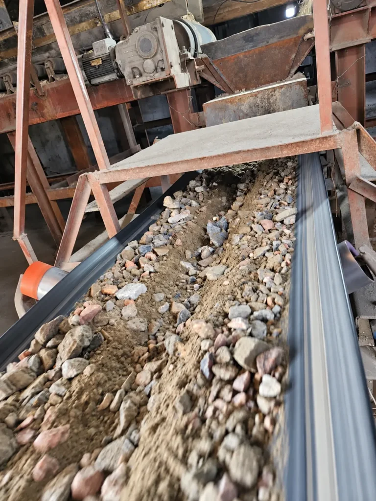 Conveyor feed close-up at the Shi and Yan mining facility