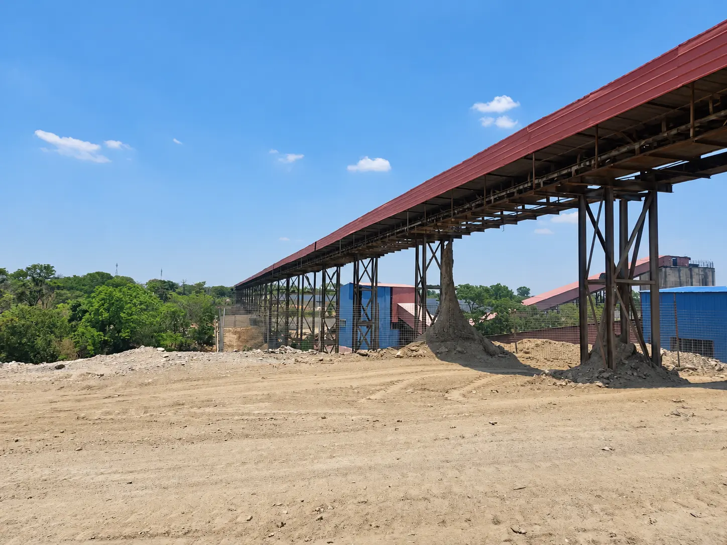 Elevated covered conveyor at the Shi and Yan mining facility