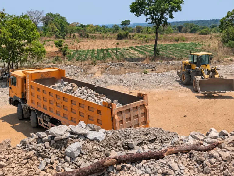 Loaded tipper and wheel loader at the Shi and Yan mining facility